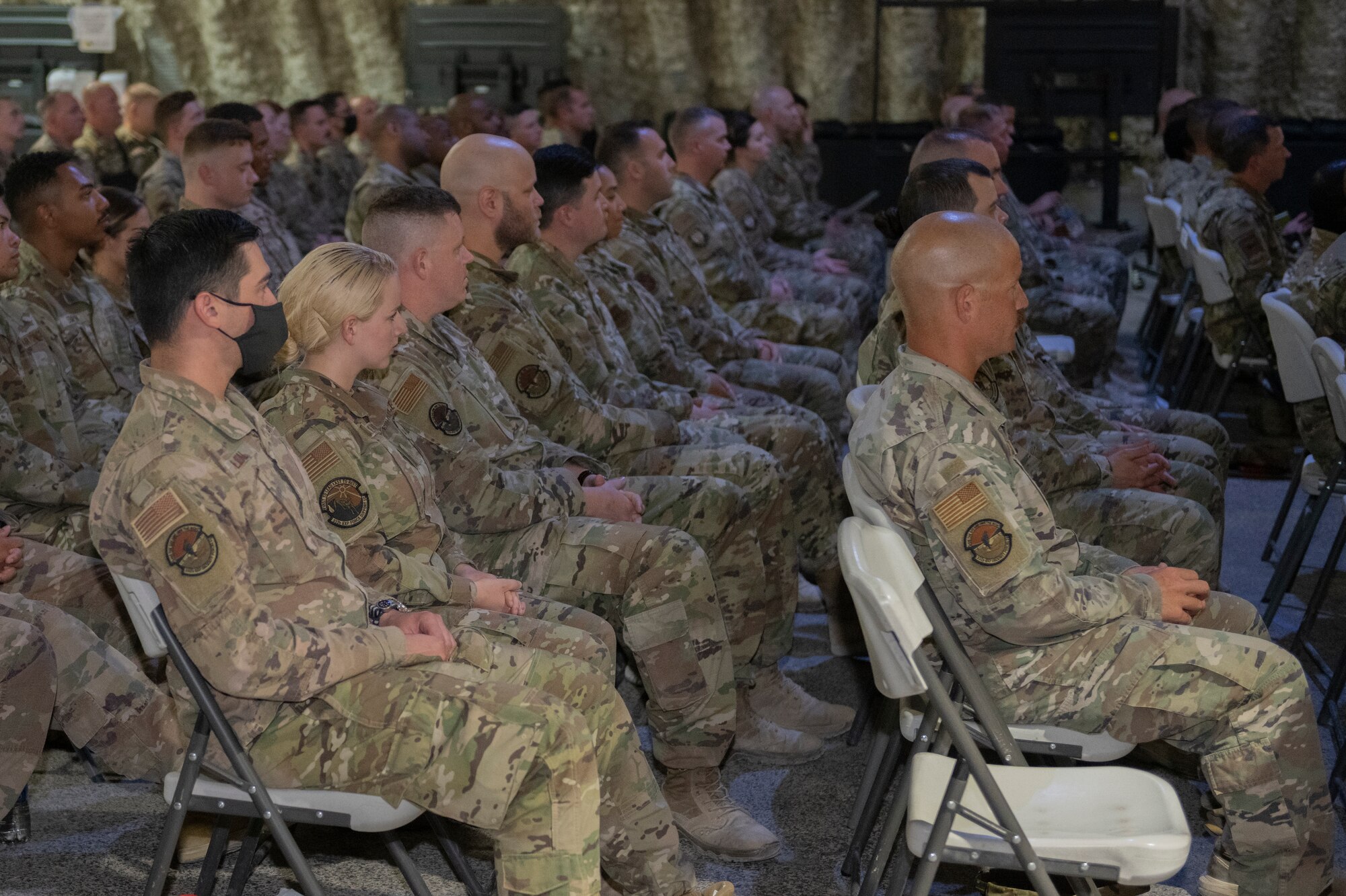 U.S. Servicemembers sit in an audience