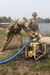 U.S. Army Cpl. Noah Borges and Spc. Garth Heinrich, water treatment specialists assigned to the 1034th Composite Supply Company, 185th Combat Sustainment Support Battalion, Iowa Army National Guard, prime the raw water pump in preparation to purify water at Howe's Lake, Camp Grayling Joint Maneuver Training Center, Michigan, during Northern Strike 21-2, Aug. 4, 2021. The 1034th CSC has supplied all water assets across the entire Northern Strike area of operations at Camp Grayling.