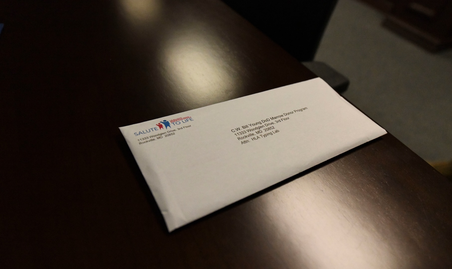 A single envelope lays on a table.