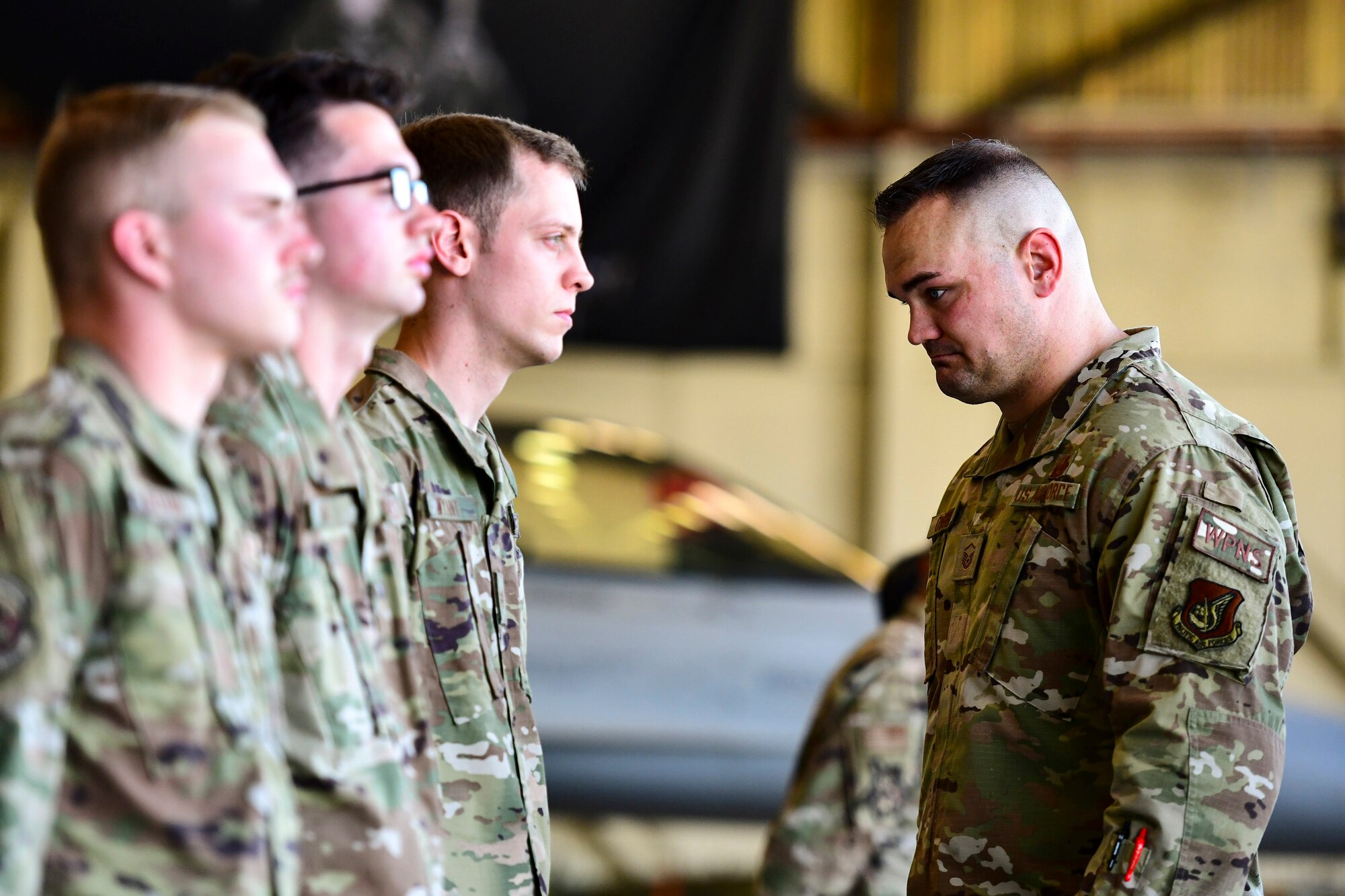 An Airman judges other Airmen's uniforms.