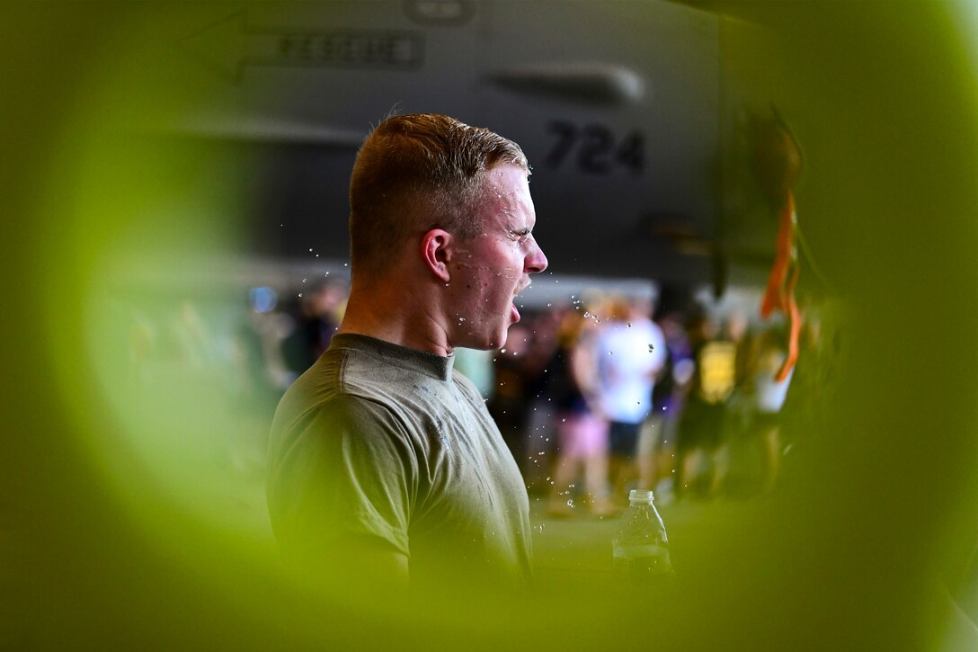 An Airman shakes water off himself.