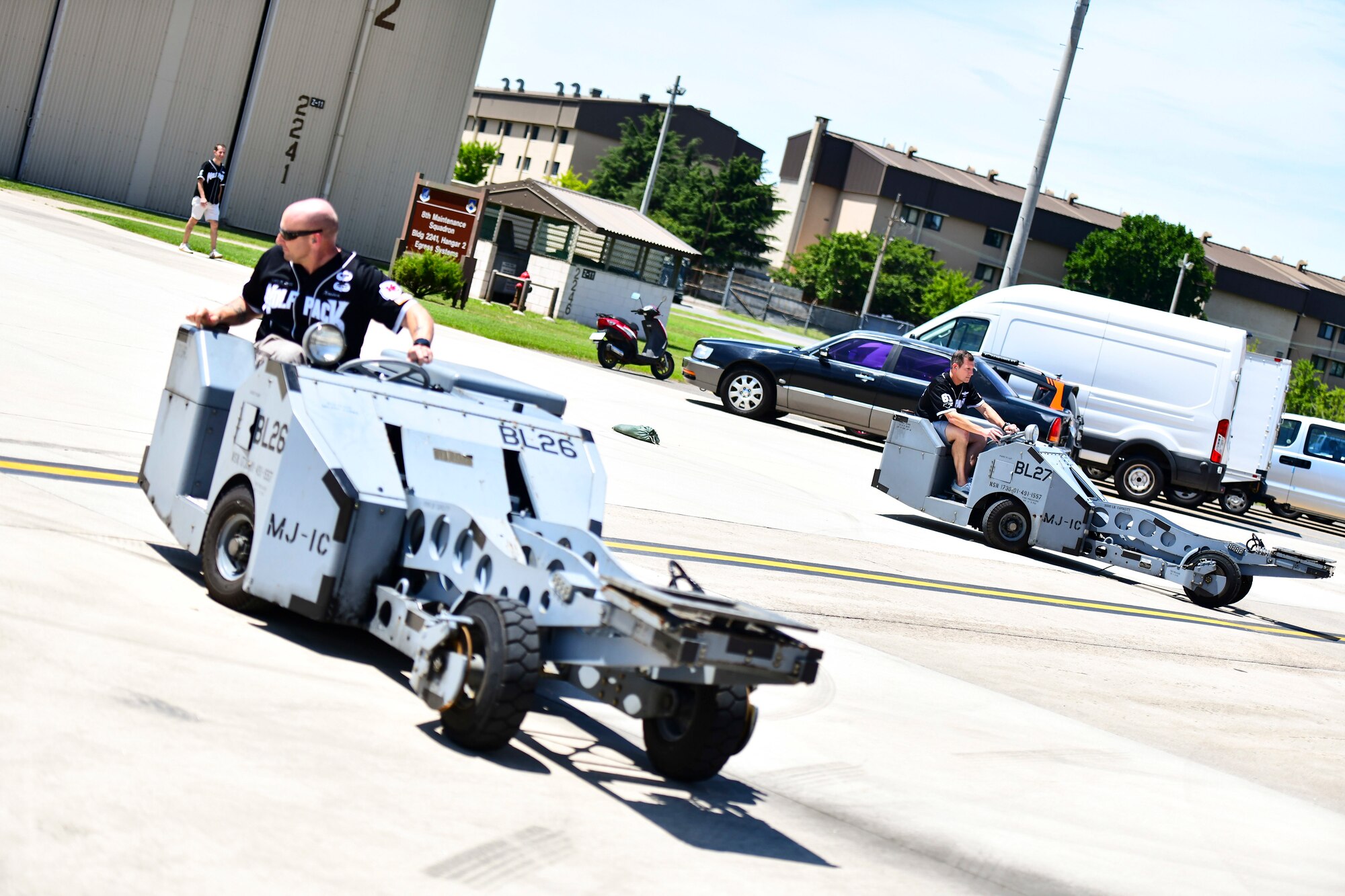 Airmen drive lift trucks.