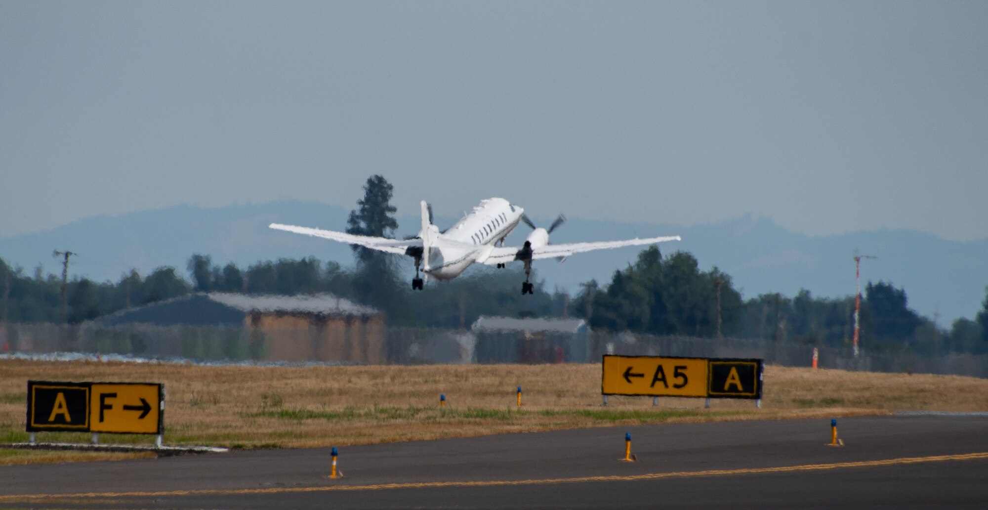 A U.S. Air Force RC-26B Metroliner aircraft assigned to the 162nd Fighter Wing, Arizona Air National Guard, departs on a wildland fire mapping and detection mission in support of the U.S. Forest Service at the Eugene Airport, Eugene, Ore., August 1, 2021.