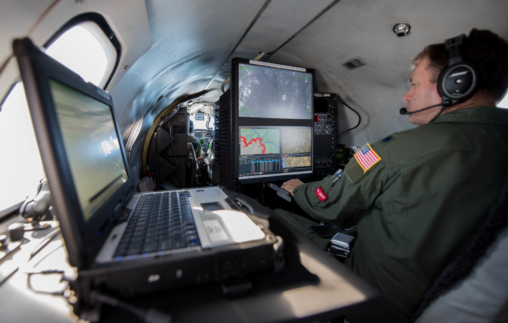 U.S. Air Force Lt. Col. Andy Rathbum, a RC-26 mission system operator assigned to the141st Operations Group, Washington Air National Guard, maps the Chetco Bar fire in southern Oregon using the RC-26s camera Sept. 2, 2017, Brookings, Oregon.