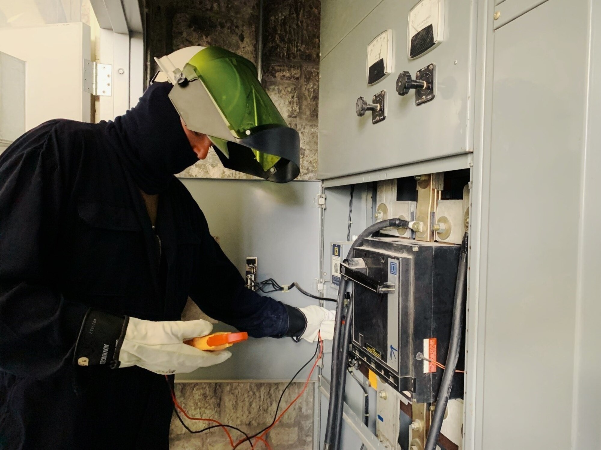Staff Sgt. Robert Moore, working in electrical protective gear, tests electric power provided by generators from the 118th Civil Engineer Squadron as it powers the Army National Guard Armory in Chattanooga.