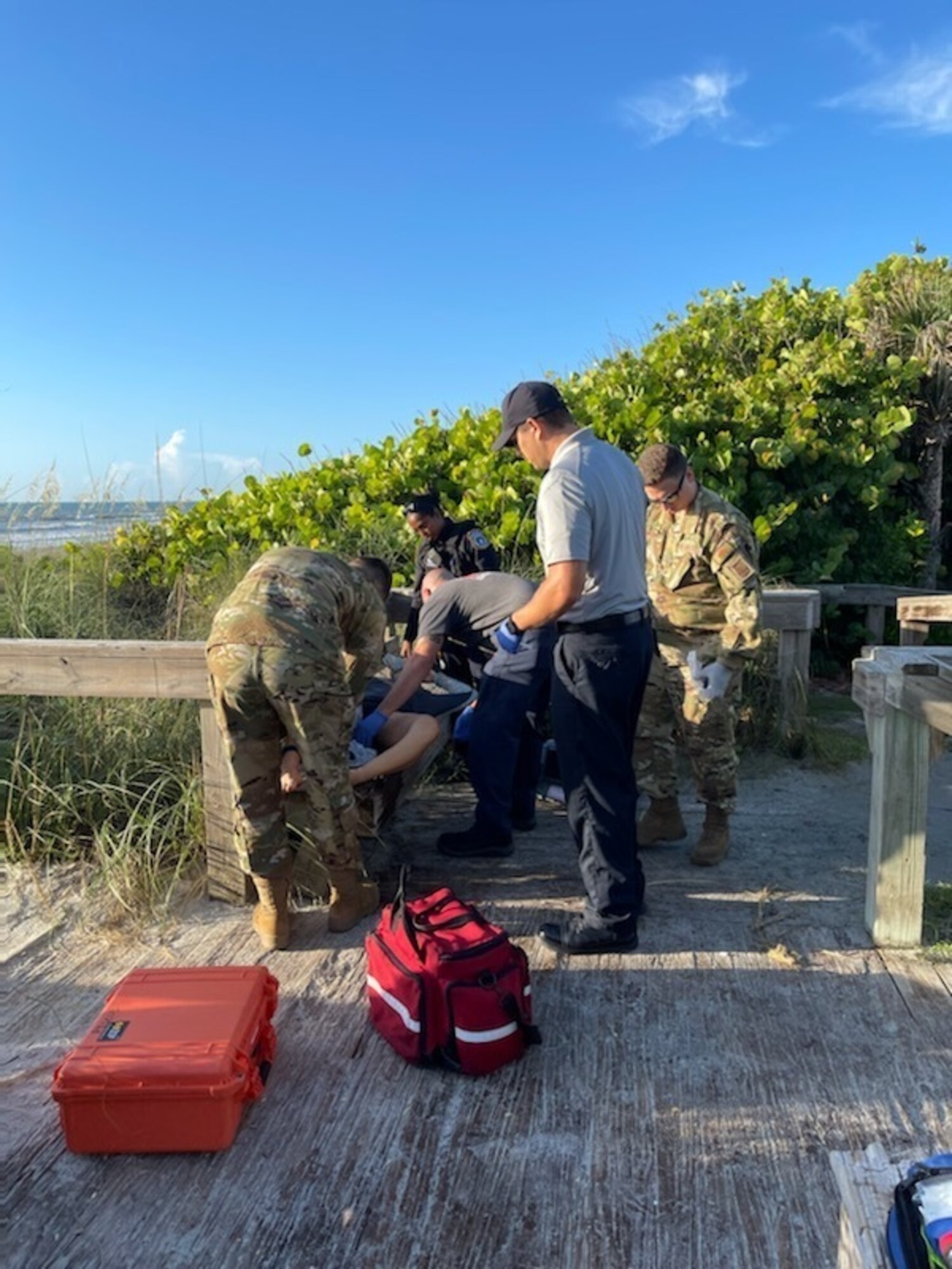 Gretta Lowry, Cocoa Beach, Florida, resident is provided life saving aid for a shark bite wound at a Patrick Space Force Base, Florida, beach June 28, 2021. Patrick Space Force Base emergency medical services provided life saving aid to Lowry after she was bitten by a shark while surfing.