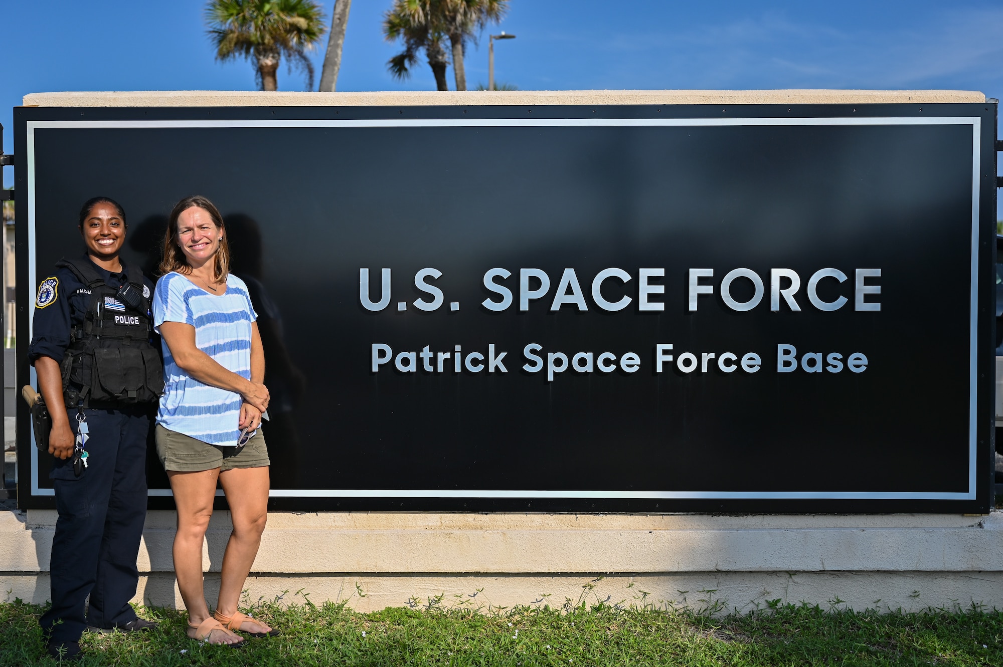Christy Kalicharan (left), 45th Security Forces Squadron police officer and Gretta Lowry (right), Cocoa Beach, Florida, resident pose for a group photo at Patrick Space Force Base, Florida, July 28, 2021. Kalicharan provided life saving aid to Lowry after she was bitten by a shark while surfing.