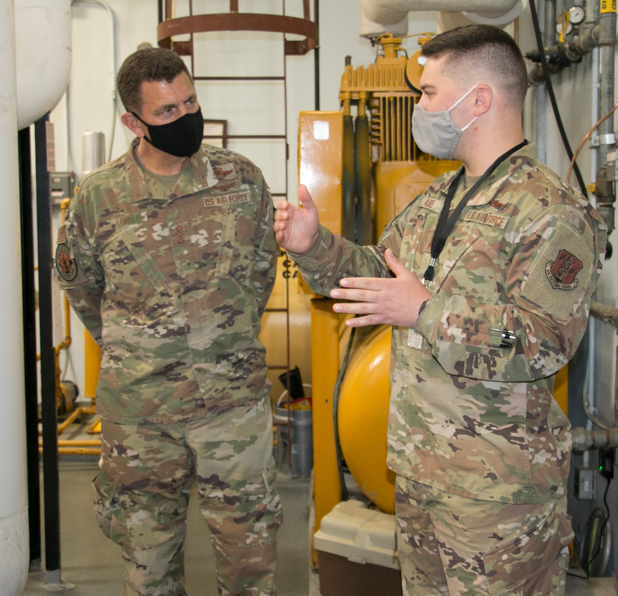 U.S. Air Force Capt. Dana Aube, right, the logistics flight commander at the Eastern Air Defense Sector (EADS), briefs Lt. Gen. Michael Loh, director, Air National Guard on the unit’s generator capacity in Rome, New York, Aug. 6, 2021. EADS conducts around-the-clock air defense operations and a robust electrical power system is essential. (U.S. Air National Guard photo by Tim Jones.)