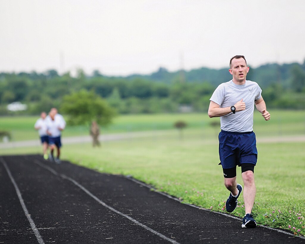 Tech. Sgt. Michael Ward, 445th Maintenance Squadron aircraft structural maintenance, pushes through to the finish line during a 1.5 mile run at Wright-Patterson Air Force Base, Ohio, July 10, 2021. Fitness testing was curtailed for nearly 18 months due to COVID-19 safety concerns. (U.S. Air Force photo/Senior Airman Erin Zimpfer)