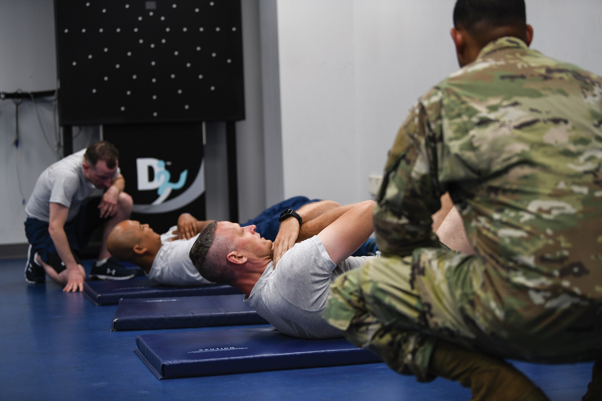 Members of the 445th Airlift Wing complete the sit-up portion of physical fitness testing at Wright-Patterson Air Force Base, Ohio, July 10, 2021 during the July unit training assembly. Fitness testing was curtailed for nearly 18 months due to COVID-19 safety concerns. (U.S. Air Force photo/Master Sgt. Patrick O’Reilly)