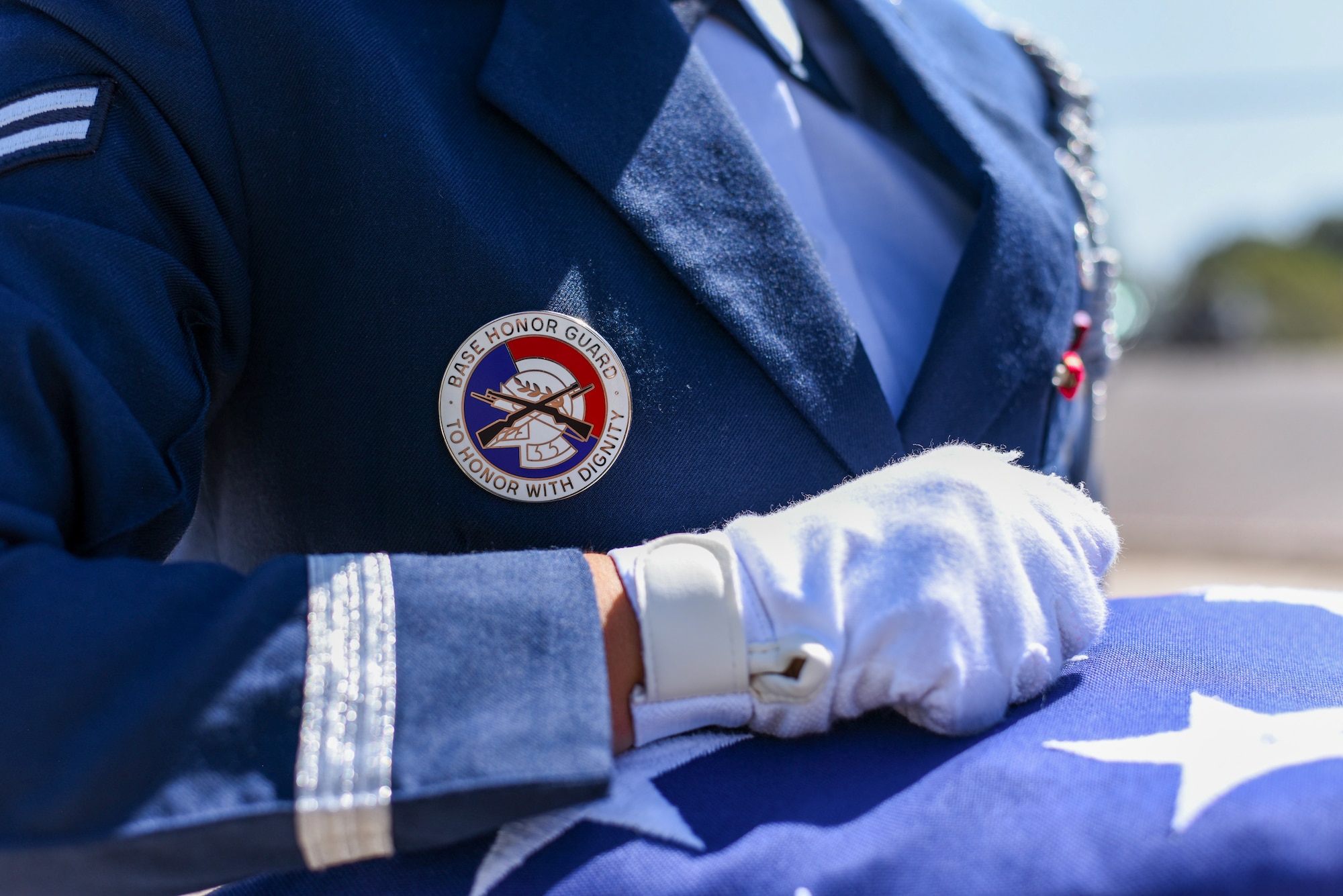 U.S. Air Force Airman 1st Class Mya Porras, 56th Fighter Wing ceremonial guardsman, holds the American flag during a flag folding ceremony July 28, 2021, at Luke Air Force Base, Arizona. The Luke AFB Honor Guard is responsible for a large amount of Arizona’s ceremonies, providing coverage to six different counties. The base honor guard’s primary mission is to provide military funeral honors for active-duty members as well as retirees and veterans who served honorably in the U.S. Air Force and Army Air Corps. (U.S. Air Force photo by Senior Airman Caleb F. Butler)