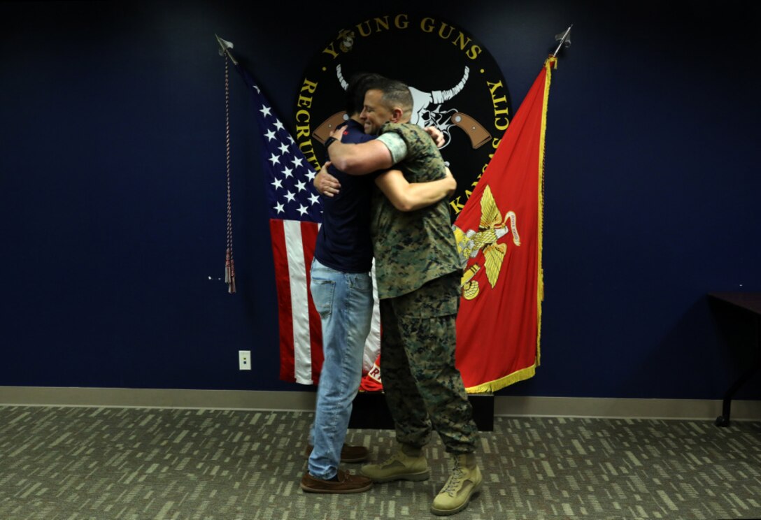 Daniel Hayek (left) and his father Maj. Richard Hayek, the Commanding officer of Marine Corps Recruiting Station Kansas City, embrace after Daniel took the Oath of Enlistment from his father at Kansas City Military Entrance Processing Station in Kansas City, Mo., July 26, 2021. By committing to the Marines, Daniel is poised to become a fourth-generation service member in his family-- following the footsteps of his mother, father, grandfather and great-grandfather. Daniel graduated from Navarre High School in Navarre, Fla., in 2020.