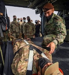 A Colombian army soldier instructs U.S. Army medics