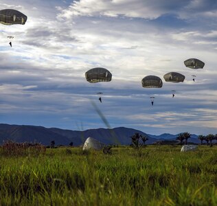 U.S. Army and Colombian joint military paratroopers land July 25 at Tolemaida Air Base, Colombia.