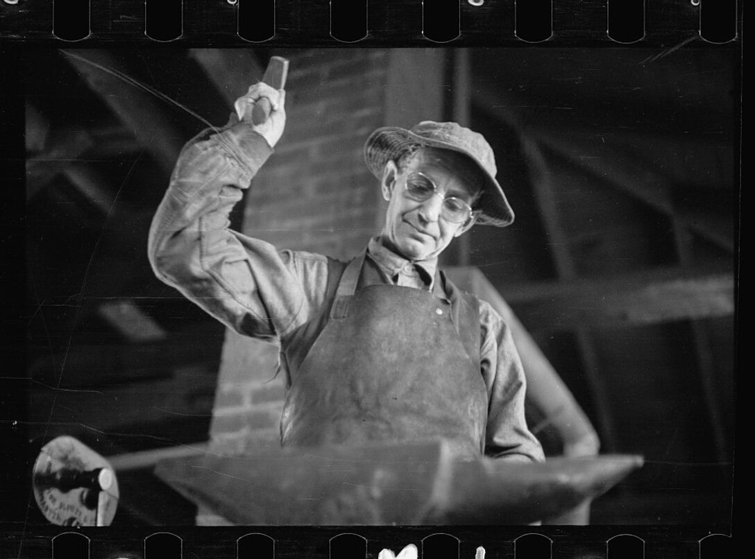A Blacksmith from Prince Georges County, Md., performs his trade as part of the Civilian Conservation Corps. in the 1930s the Philadelphia Quartermaster Depot manufactured working clothes for 600,000 members of the Corps.