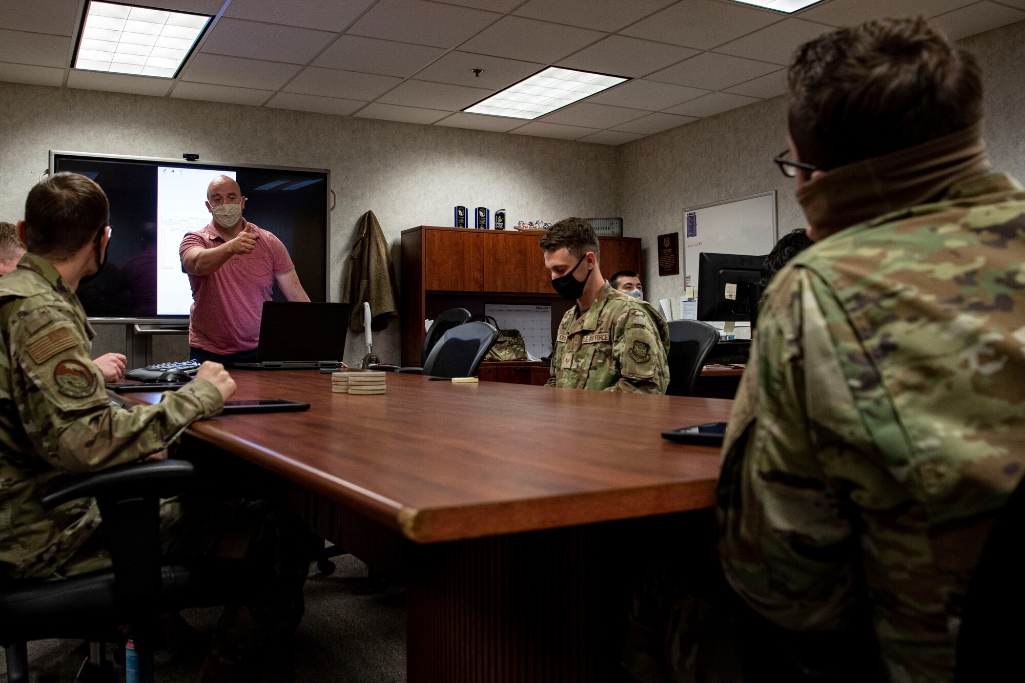 Airmen assigned to the 305th Aerial Port Squadron attending a brief about the Real-time Hybrid Internet of Things Networked Operations (RHINO) application.
