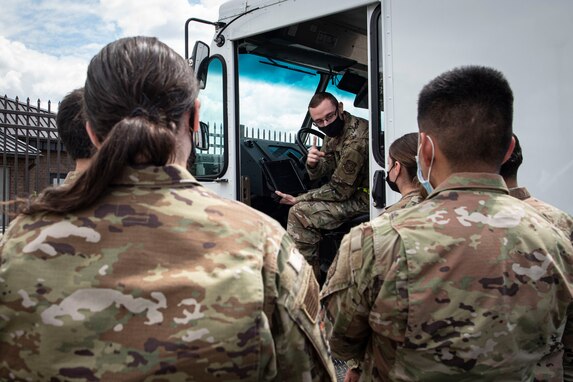 Photo of Airman briefing 305th APS Airmen about the Real-time Hybrid Internet of Things Networked Operations (RHINO) application.