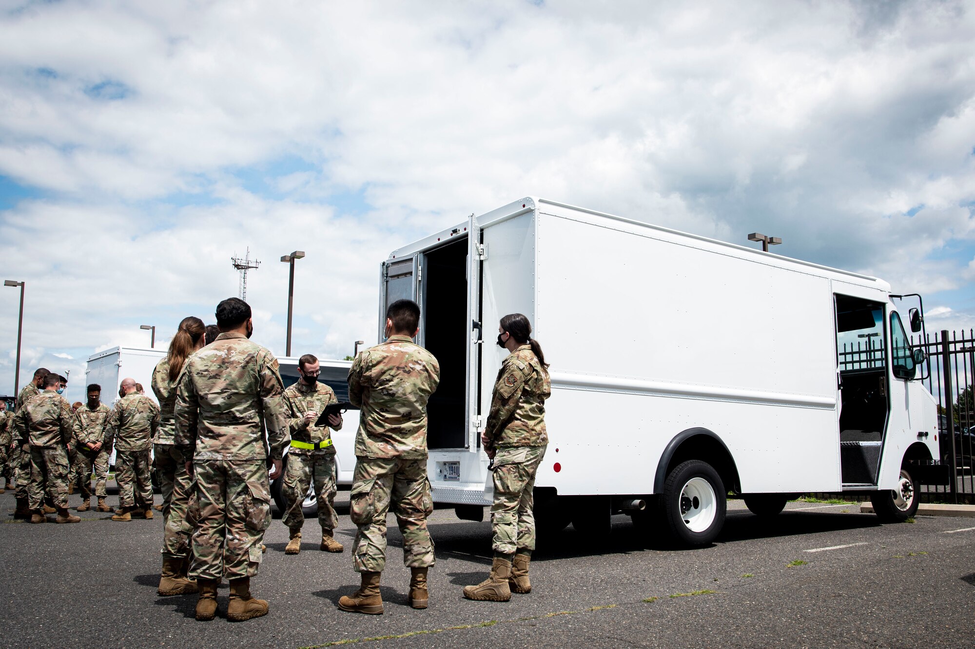 Photo of Airmen assigned to the 305th Aerial Port Squadron testing the Real-time Hybrid Internet of Things Networked Operations (RHINO) application.