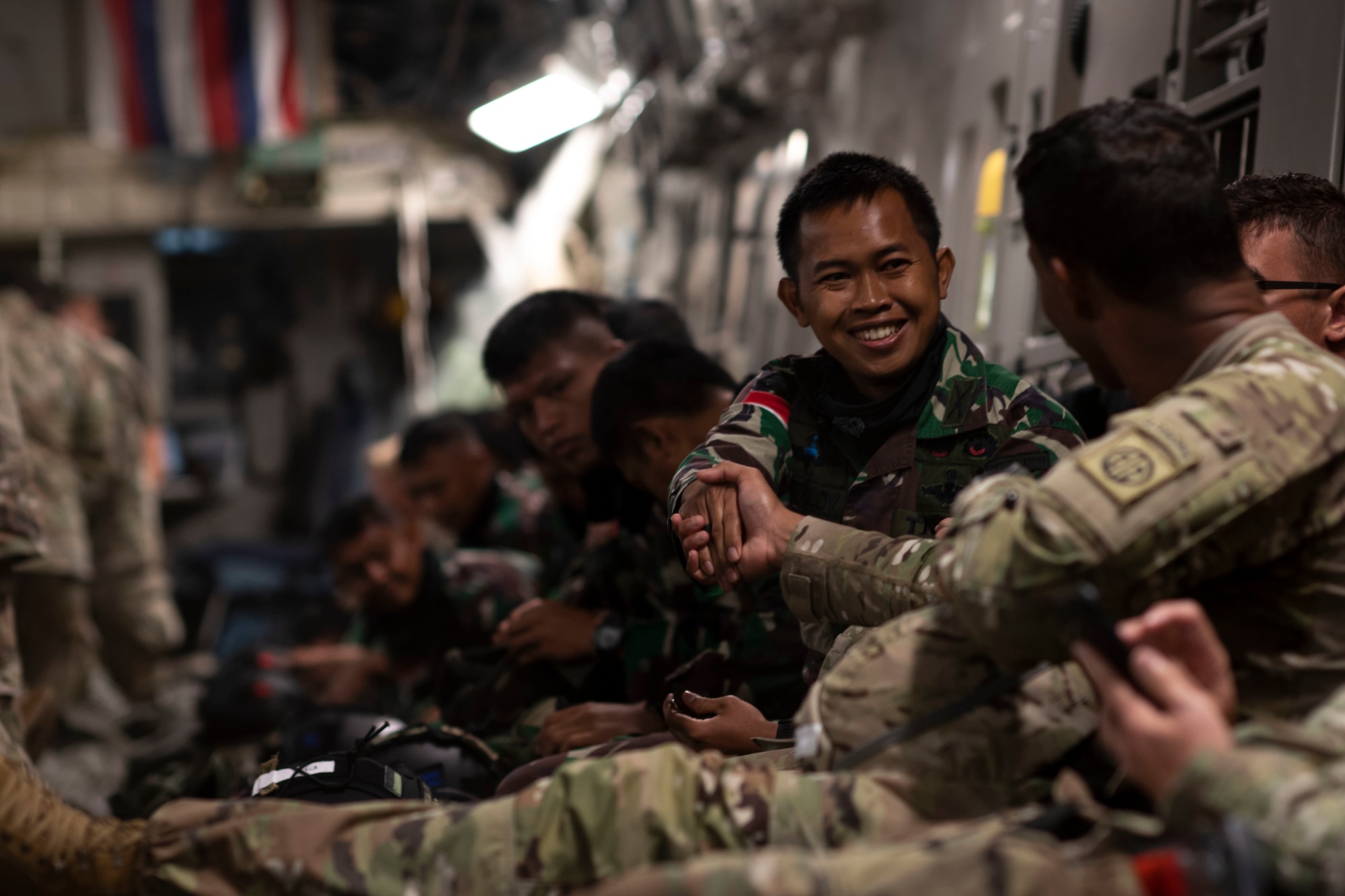 An Indonesian paratrooper shakes hands with a U.S. Army Soldier.