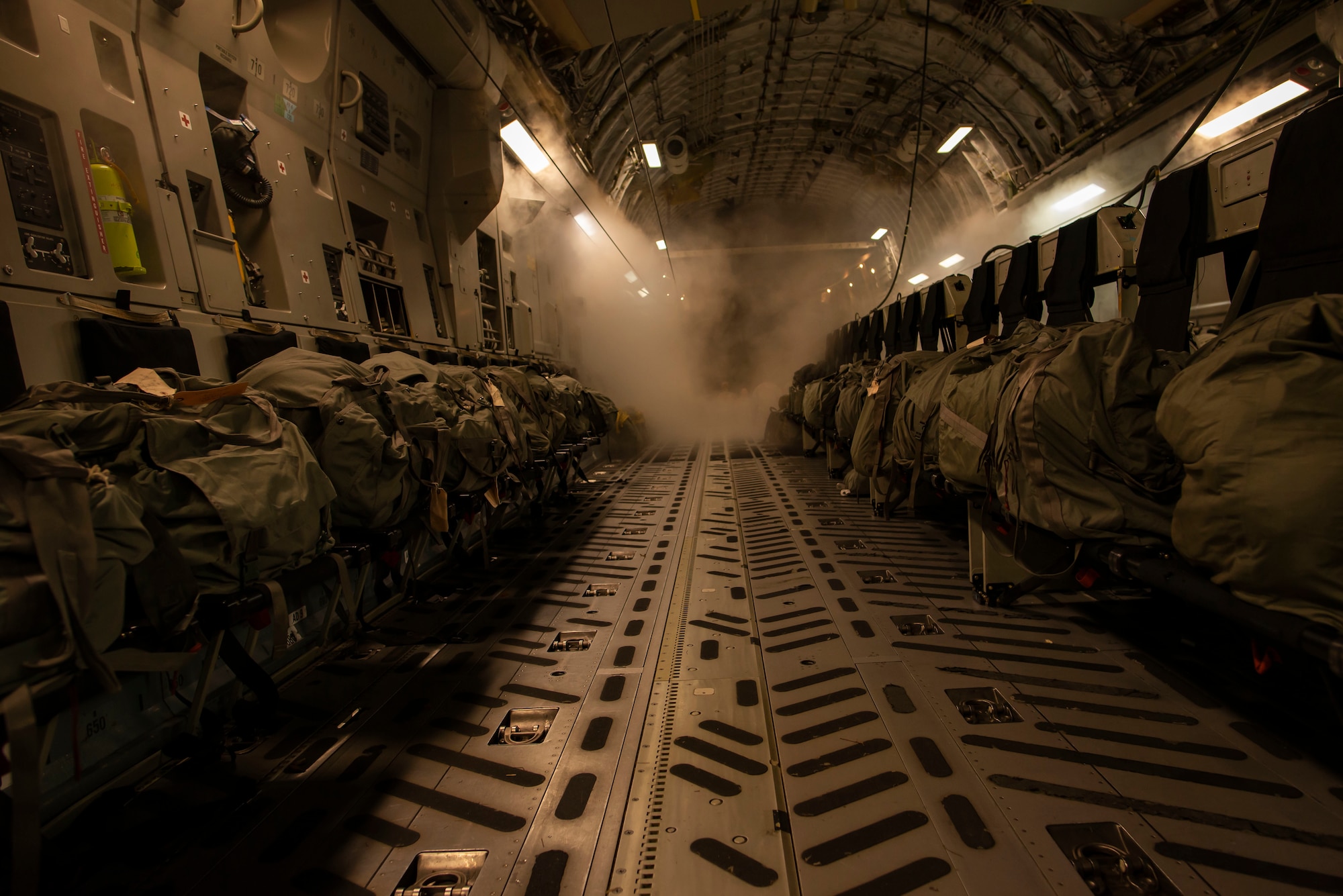 The walkway of a plane before paratroopers board the plane.