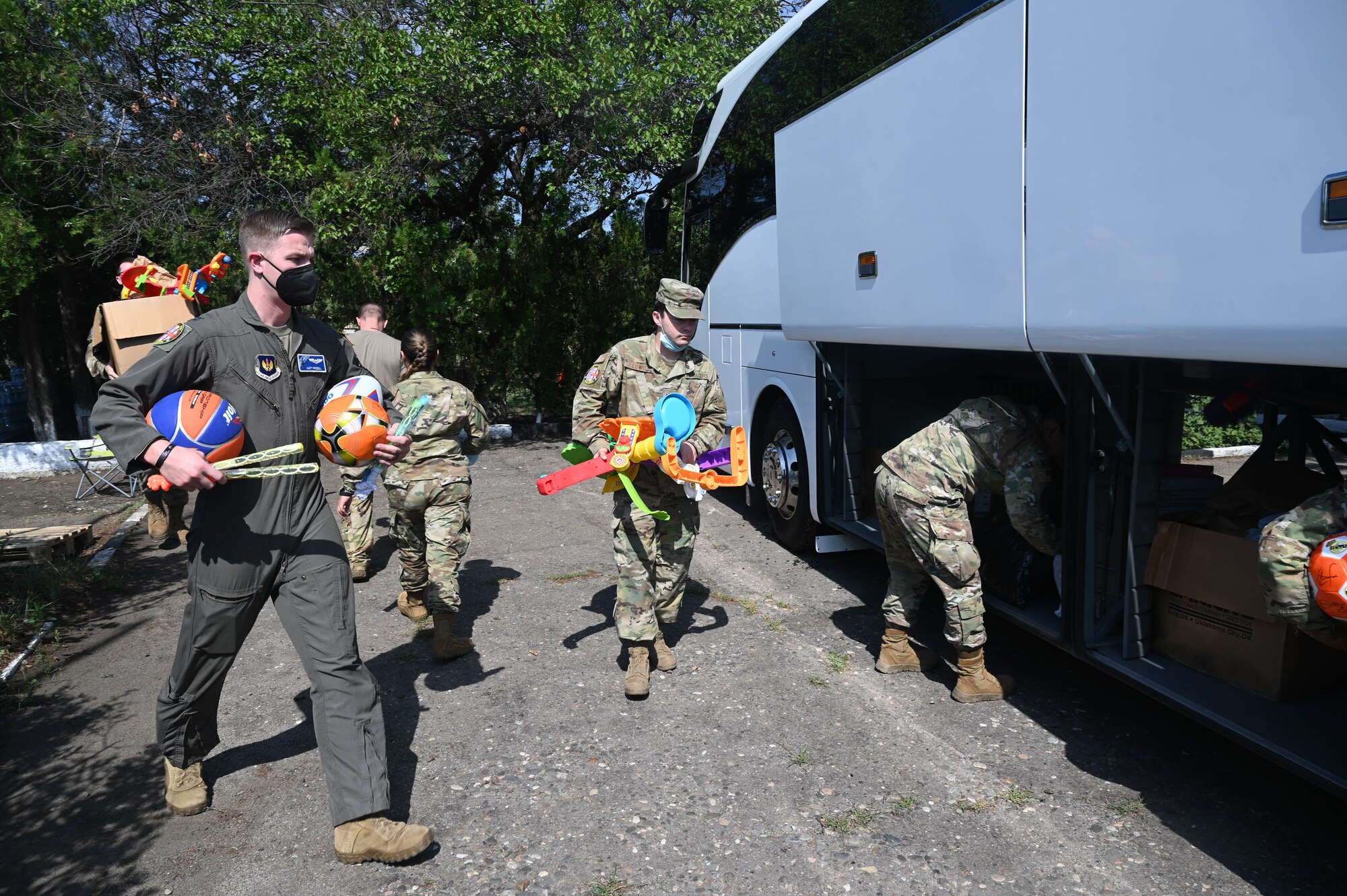 U.S. Air Force Airmen assigned to Ramstein Air Base, Germany, load a bus full of toys and clothes in preparation for a humanitarian event for the children of Vaziani, Georgia during exercise Agile Spirit 21