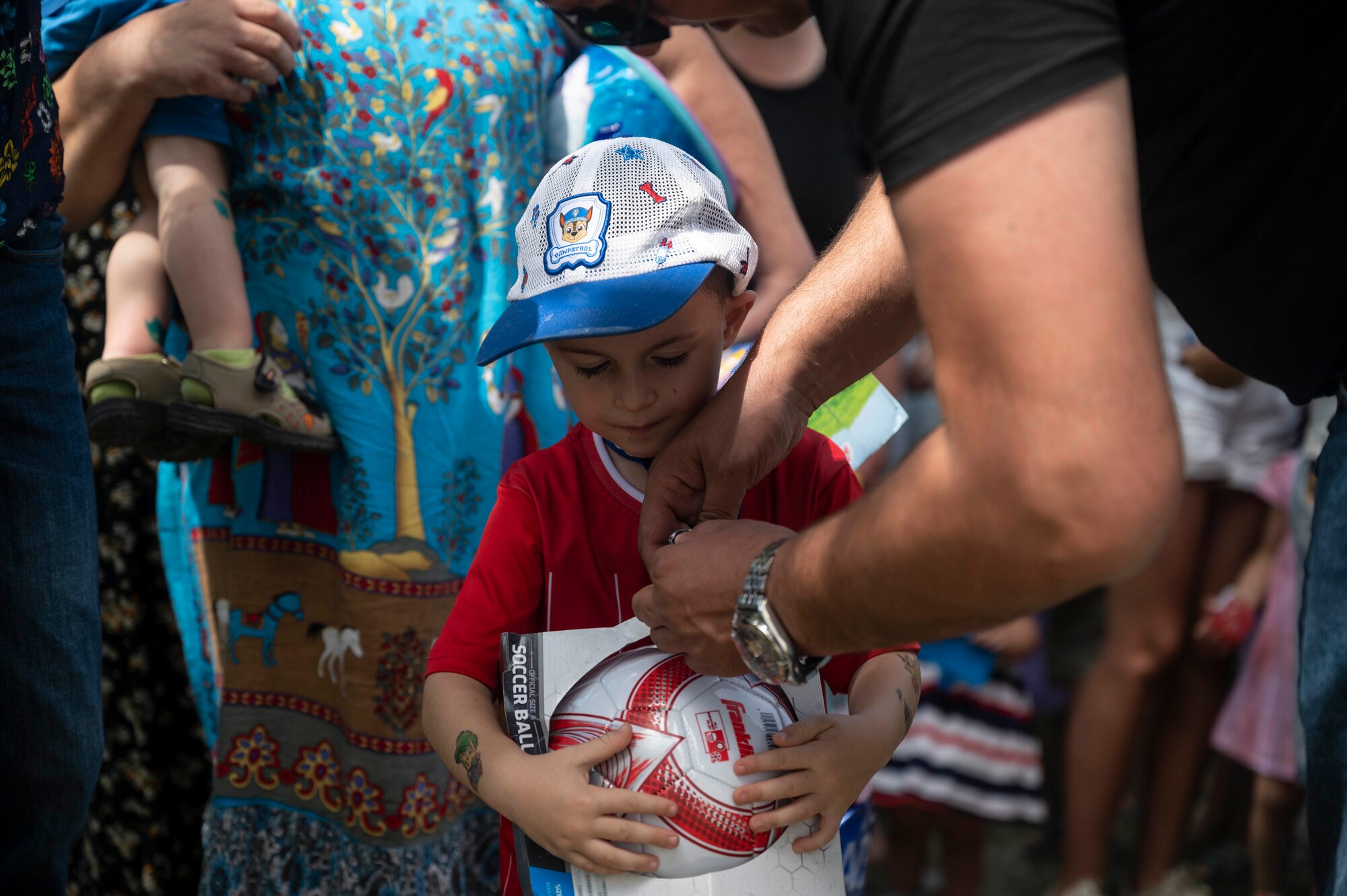 Levan Menakhshirishvili, Vaziani mayor, opens a box for a child during a toy giveaway during exercise Agile Spirit 21