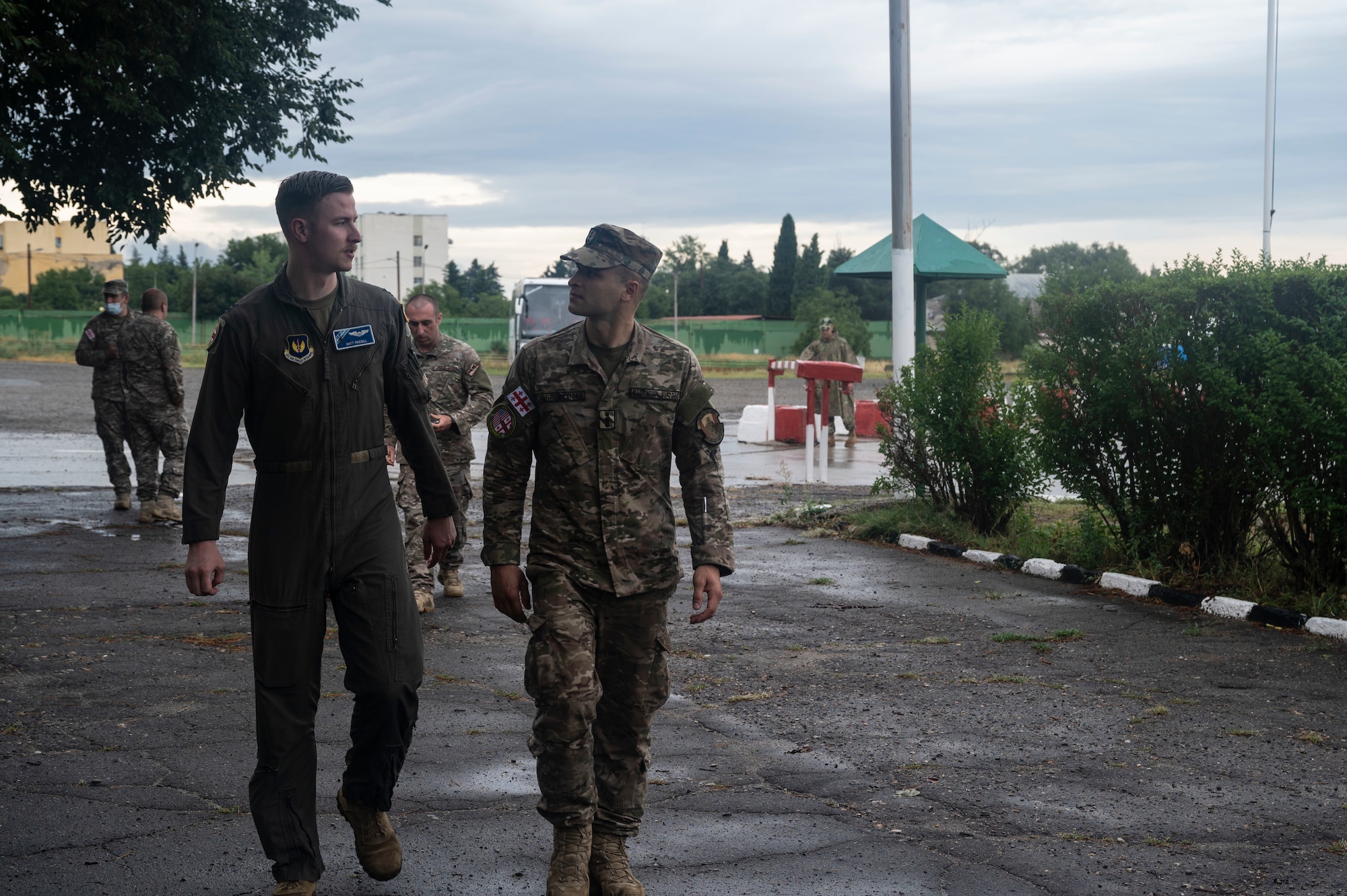 U.S. Air Force Capt. Matthew Frizzell, 37th Airlift Squadron instructor pilot, left, and 1st Lt. Nika Girgvlini, Georgian army avionic mechanic specialist, talk during exercise Agile Spirit 21