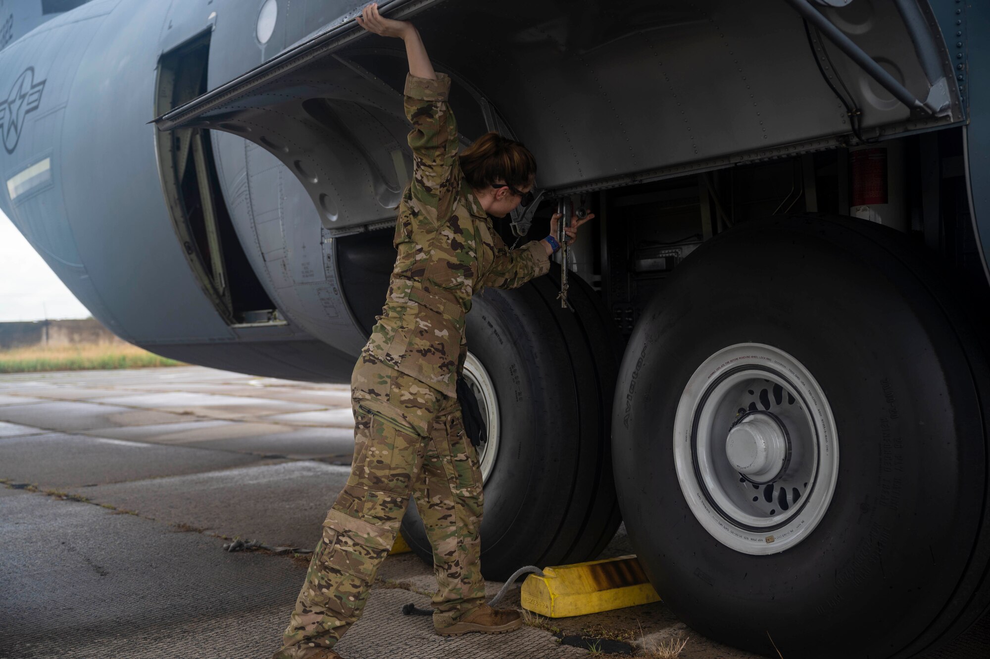 U.S. Air Force Senior Airman Anibel MacRae, 86th Aircraft Maintenance Squadron, flying crew chief assistant, opens a C-130J Super Hercules aircrafts’ landing gear doors during exercise Agile Spirit 21