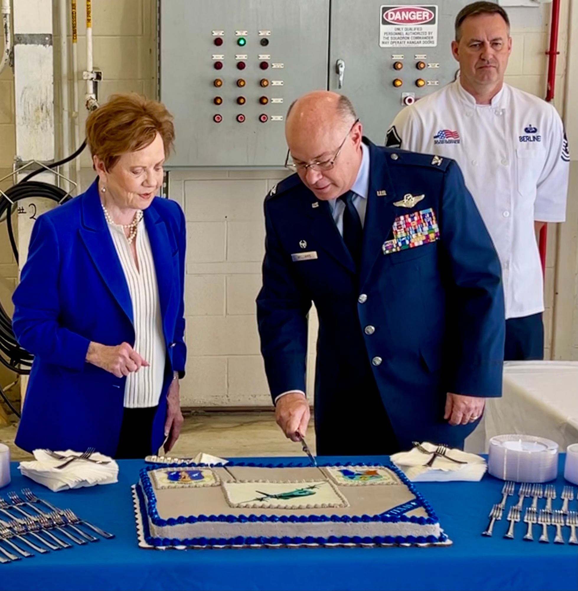 Col Williams cuts a cake with Congresswoman Granger.