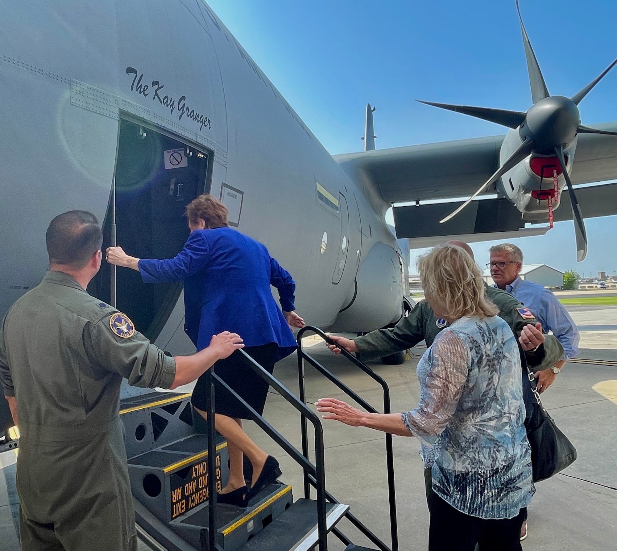 People enter C-130J doorway.