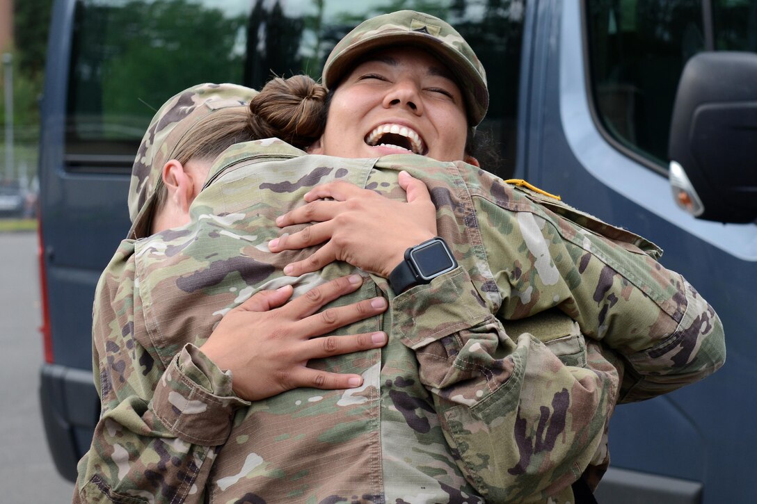 Two soldiers hug each other.