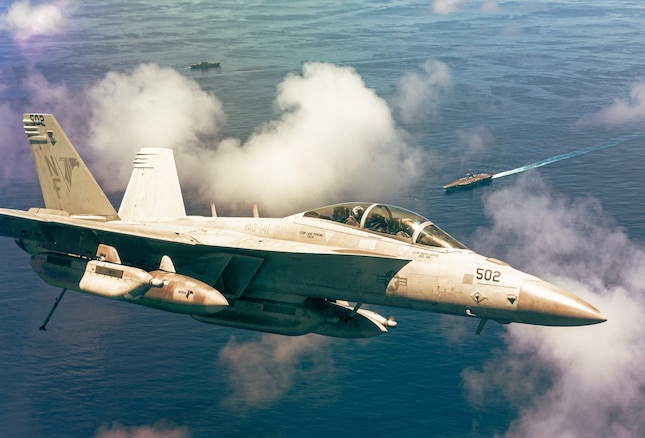 ARABIAN SEA (Aug. 9, 2021) – Lt. Derrick Petett and Lt. Melissa Deardorff, pilots assigned to the “Shadowhawks” of Electronic Attack Squadron (VAQ) 141, fly an EA-18G Growler above USS Ronald Reagan (CVN 76) over the Arabian Sea, Aug. 9. VAQ-141 is attached to Carrier Air Wing 5, the air wing of Commander, Task Force 50, deployed to the U.S. 5th Fleet area of operations in support of naval operations to ensure maritime stability and security in the Central Region, connecting the Mediterranean and Pacific through the western Indian Ocean and three strategic choke points. (U.S. Navy photo by Electronic Attack Squadron (VAQ) 141)