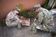 Senior Airman Alec Moore, 2nd Civil Engineer Squadron explosive ordnance disposal technician, and Col. Mark Dmytryszyn, 2nd Bomb Wing commander, inspect a simulated improvised explosive device at Barksdale Air Force Base, Louisiana, Aug. 9, 2021. Airmen from the EOD shop walked Dmytryszyn through a simulated operation in which he neutralized a simulated improvised explosive device using a percussion actuated neutralizer. (U.S. Air Force photo by Senior Airman Jacob B. Wrightsman)