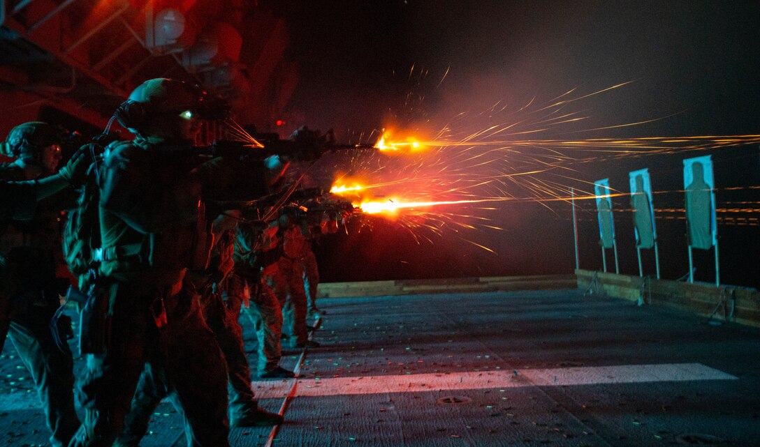 U.S. Marines with Force Reconnaissance Platoon, 31st Marine Expeditionary Unit, practice recoil management drills utilizing tracers during a deck shoot aboard amphibious assault ship USS America (LHA 6) in the Solomon Sea on Aug. 5, 2021. The deck shoot consisted of reconnaissance Marines practicing close quarter combat drills and multi target engagements. The 31st MEU is operating aboard ships of the America Expeditionary Strike Group in the 7th fleet area of operation to enhance interoperability with allies and partners and serve as a ready response force to defend peace and stability in the Indo-Pacific region.