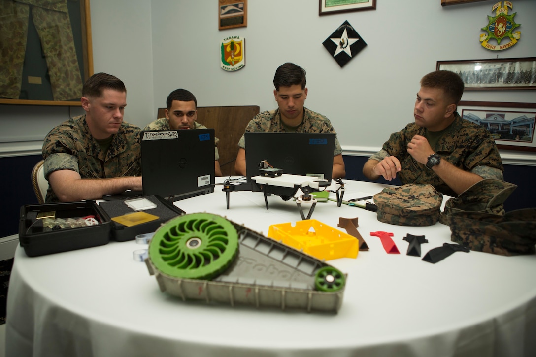 Marines work with unmanned systems.