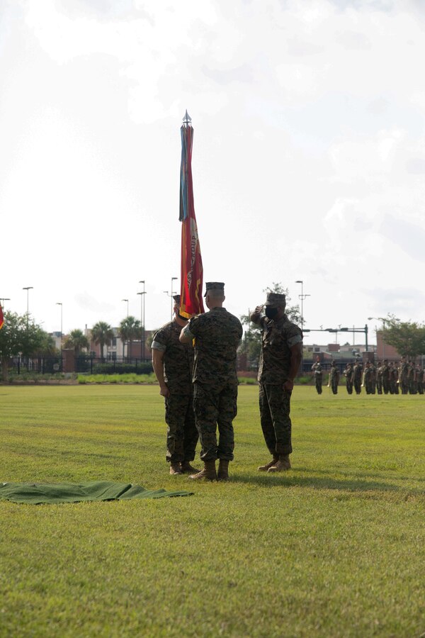 Brig. Gen. Karl Pierson, outgoing commander of 4th Marine Logistics Group (MLG), relinquishes command to Brig. Gen. William E. Souza III during a Change of Command ceremony at Marine Corps Support Facility New Orleans on Aug. 7, 2021. Change of Command ceremonies mark the passage of command from one Marine to another, symbolizing the transfer of responsibilities of his or her command position. (U.S. Marine Corps photo by Sgt. Emily Kirk)
