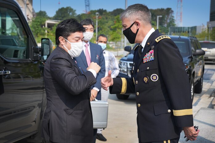 U.S. Army Gen. Paul M. Nakasone, U.S. Cyber Command commander and National Security Agency director, greets the Honorable Yasuhide Nakayama, Japan Ministry of Defense, State Minister of Defense, at Fort George G. Meade, Md., Aug. 9, 2021.