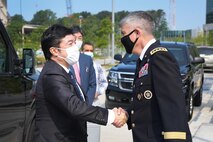 U.S. Army Gen. Paul M. Nakasone, U.S. Cyber Command commander and National Security Agency director, greets the Honorable Yasuhide Nakayama, Japan Ministry of Defense, State Minister of Defense, at Fort George G. Meade, Md., Aug. 9, 2021.