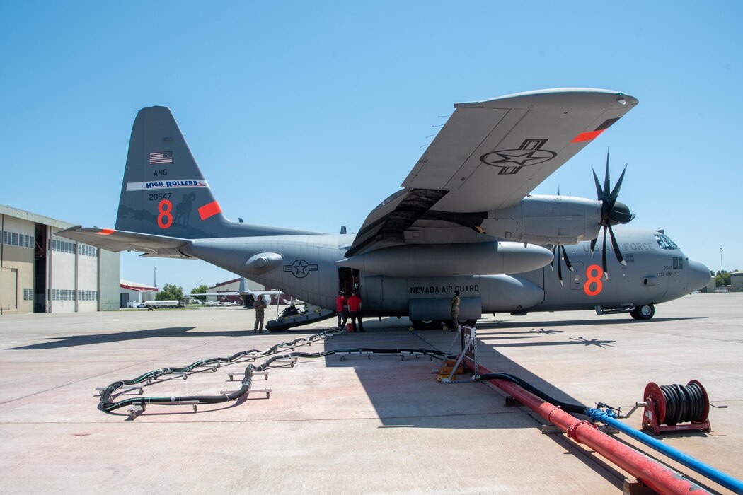 CAL FIRE employees load retardant into the MAFFS system of an Air National Guard C-130, designated "MAFFS 8 out of Reno, Nev." July 13, 2021, from CAL FIRE Air Tanker Base, McClellan Park, Calif.