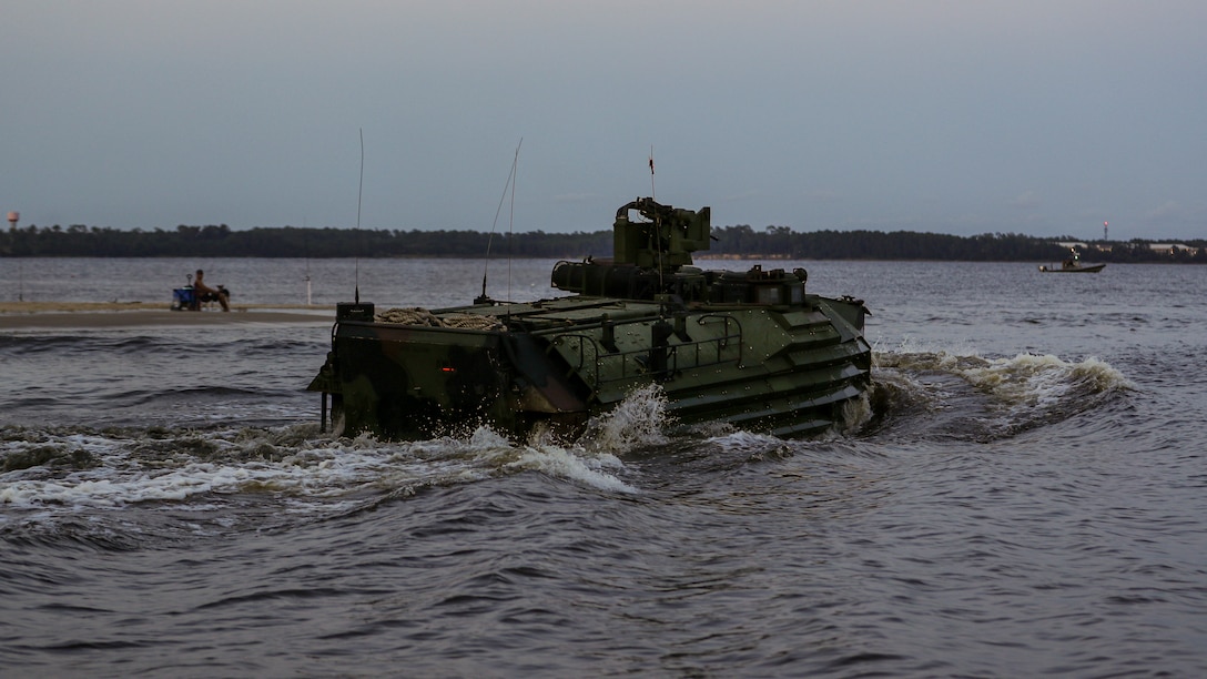 An AAV7A1 assault amphibious vehicle conducts a wet-gap amphibious crossing as part of a company-sized infiltration on Camp Lejeune, N.C., Aug. 10, 2021. The infiltration focused on maneuvering across complex terrain and picket lines with near-peer capabilities in an unscripted force-on-force scenario. (U.S. Marine Corps photo by Lance Cpl. Jacqueline C. Arre)