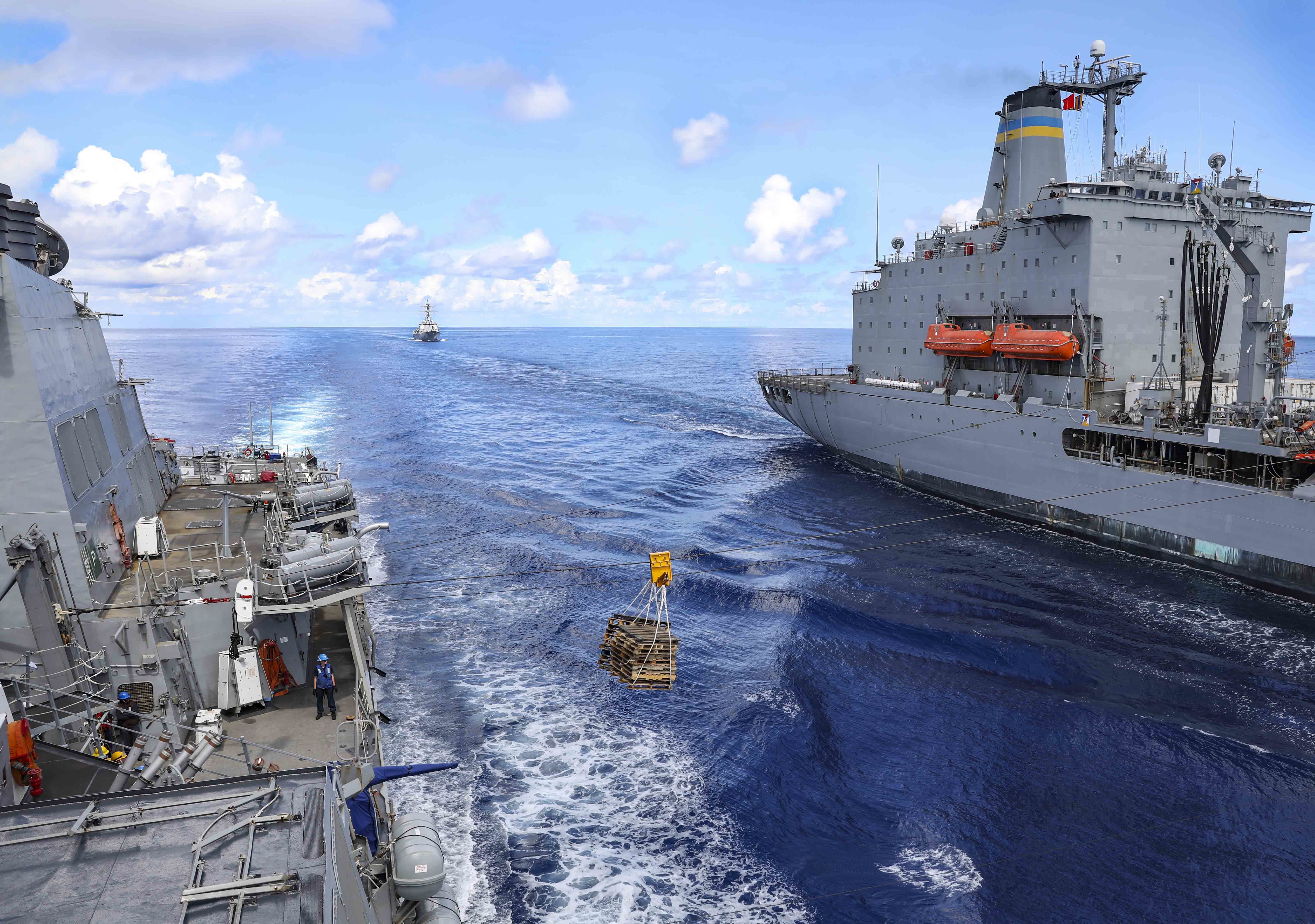 The Arleigh Burke-class guided-missile destroyer USS Benfold (DDG 65) conducts a replenishment-at-sea.