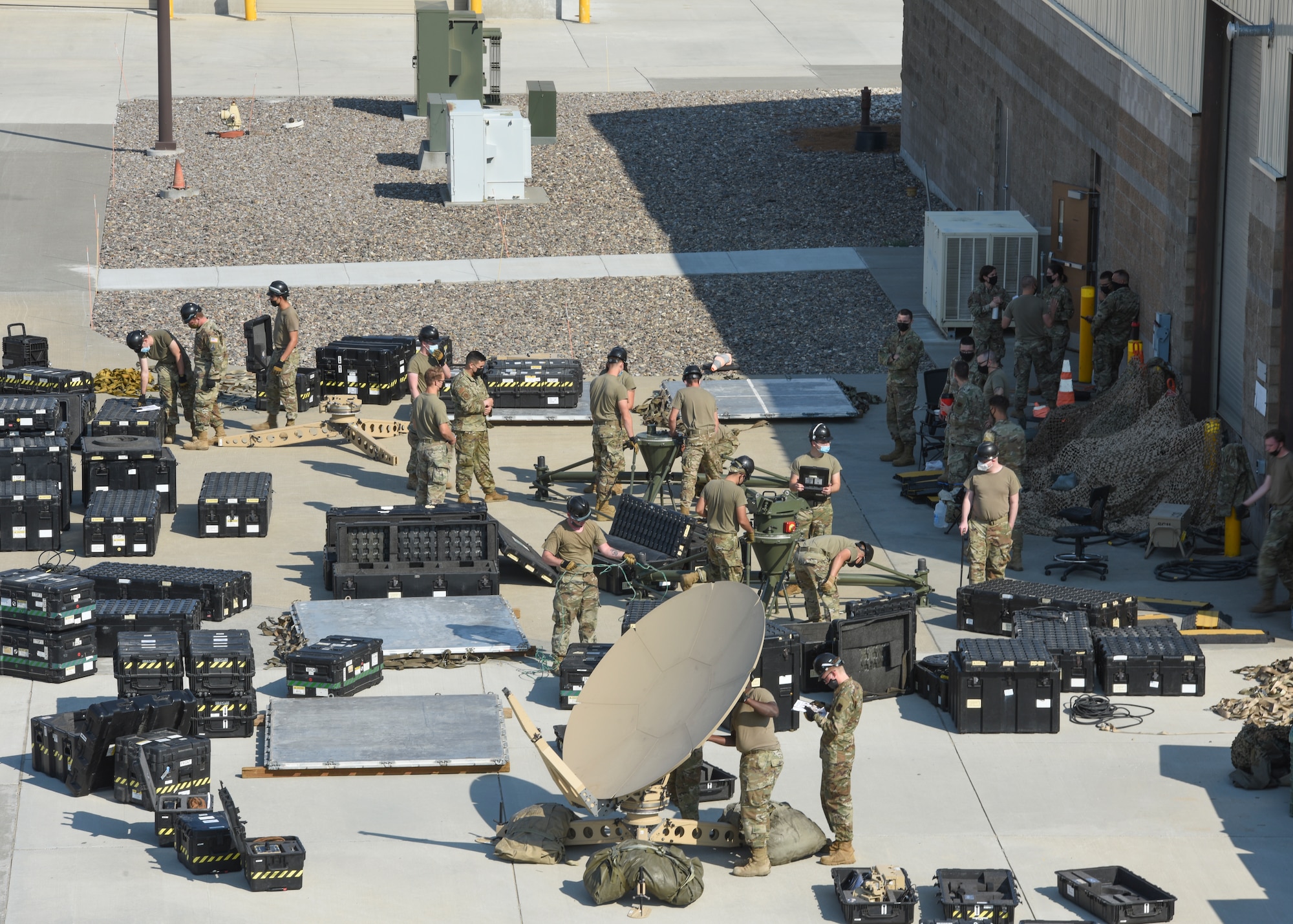 726th Air Control Squadron Airmen begin working on the production of satellite antennas.
