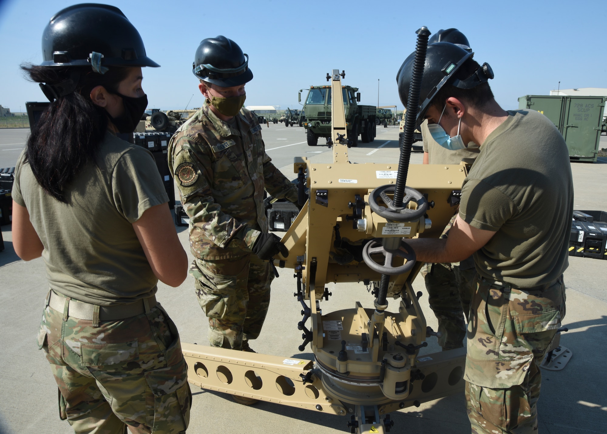 726th Air Control Squadron Airmen work together to install an elevation jack to the base of an Airbus Ranger antenna.