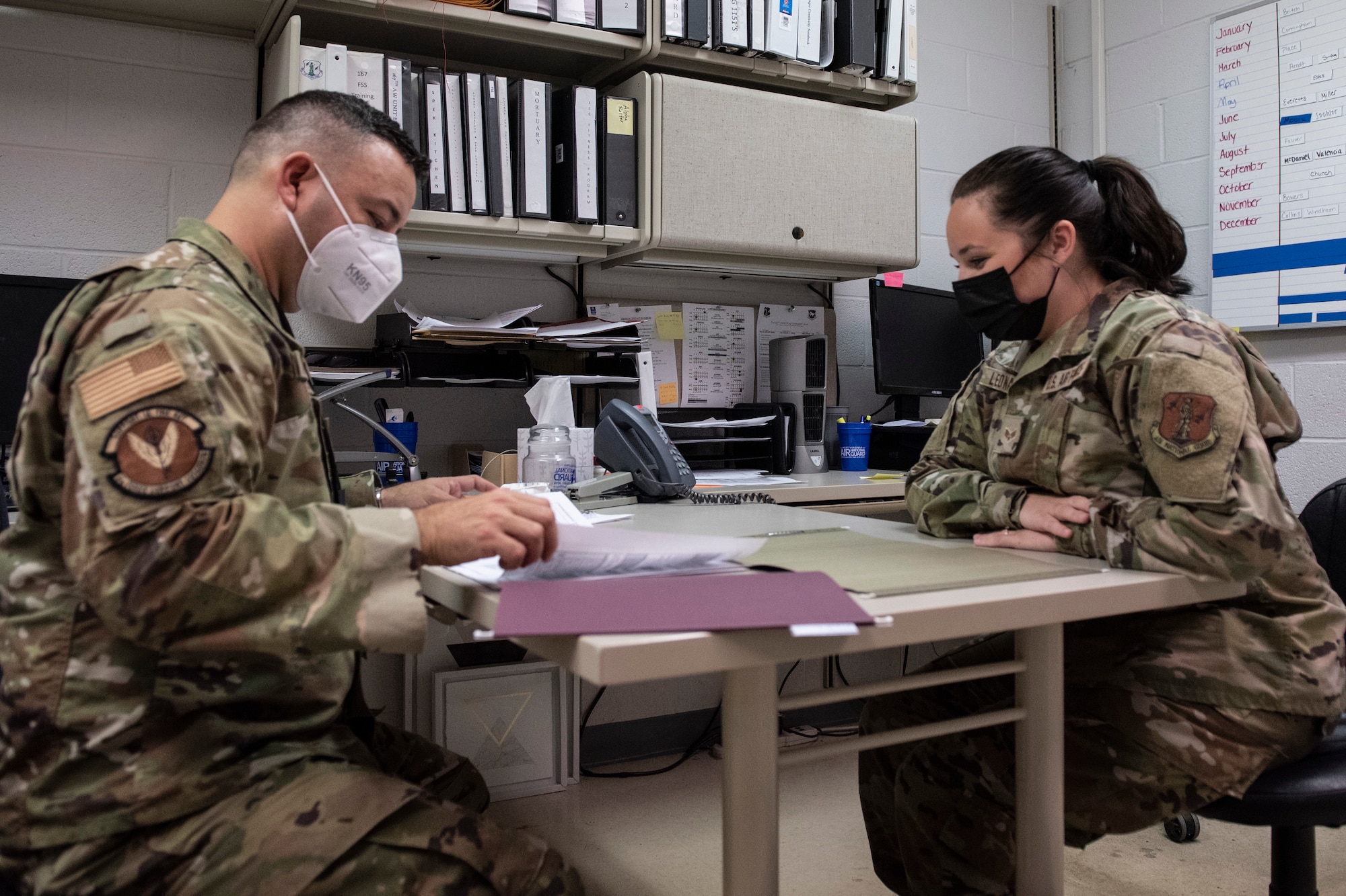 U.S. Air Force Master Sgt. Aguirre Alger Guan an inspector with Air Mobility Command, talks with Senior Airman Lauren Leonard, unit training manager with the 167th Force Support Squadron, about the master training plan, Martinsburg, West Virginia, Aug., 8, 2021. Members of the AMC Inspector General completed a capstone visit with the 167th Airlift Wing over August unit training assembly, to gain information that ultimately generates a unit effectiveness inspection report.