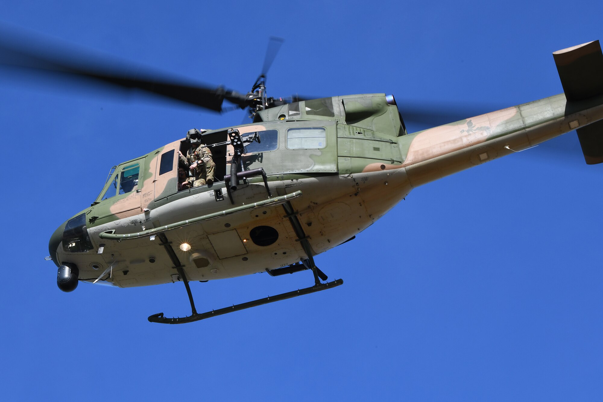 A UH-1N Huey helicopter and personnel from the 40th Helicopter Squadron are shown as they prepare to land at the Cascade school during a Local Integrated Response Plan exercise Aug 9, 2021, in Cascade Mont. Members of the Cascade community were able to speak with 40th Helicopter Squadron personnel, sit inside of the helicopters and ask questions about the security provided by the squadron. (U.S. Air Force photo by Airman Elijah Van Zandt)