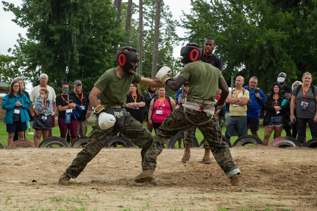 Educators observe  recruits conduct martial arts training at Marine Corps Recruit Depot Parris Island, Sc., August 5, 2021. Marine Corps Recruiting Command conducts educators workshops annually to show high school educators, coaches, and counselors  the process of becoming a Marine and to raise awareness of the opportunities for their students in the Corps. (U.S. Marine Corps photo by Lance Cpl. Jennifer Sanchez)