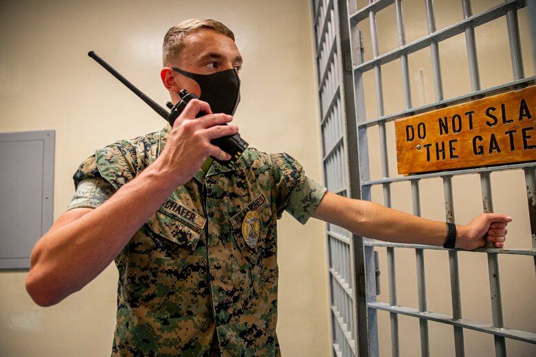 U.S. Marine Corps Lance Cpl. Zachary Schafer, a correctional specialist with the Marine Corps Installations Pacific (MCIPAC) Brig, communicates with his Marines on Camp Hansen, Okinawa, Japan, Aug. 5, 2021. Born and raised in Lincoln, Illinois, Schafer always had aspirations to join the ranks of law enforcement. As a correctional specialist, Schafer is responsible for the well-being, good order and security of the prisoners at the MCIPAC Brig. (U.S. Marine Corps photo by Lance Cpl. Alex Fairchild)