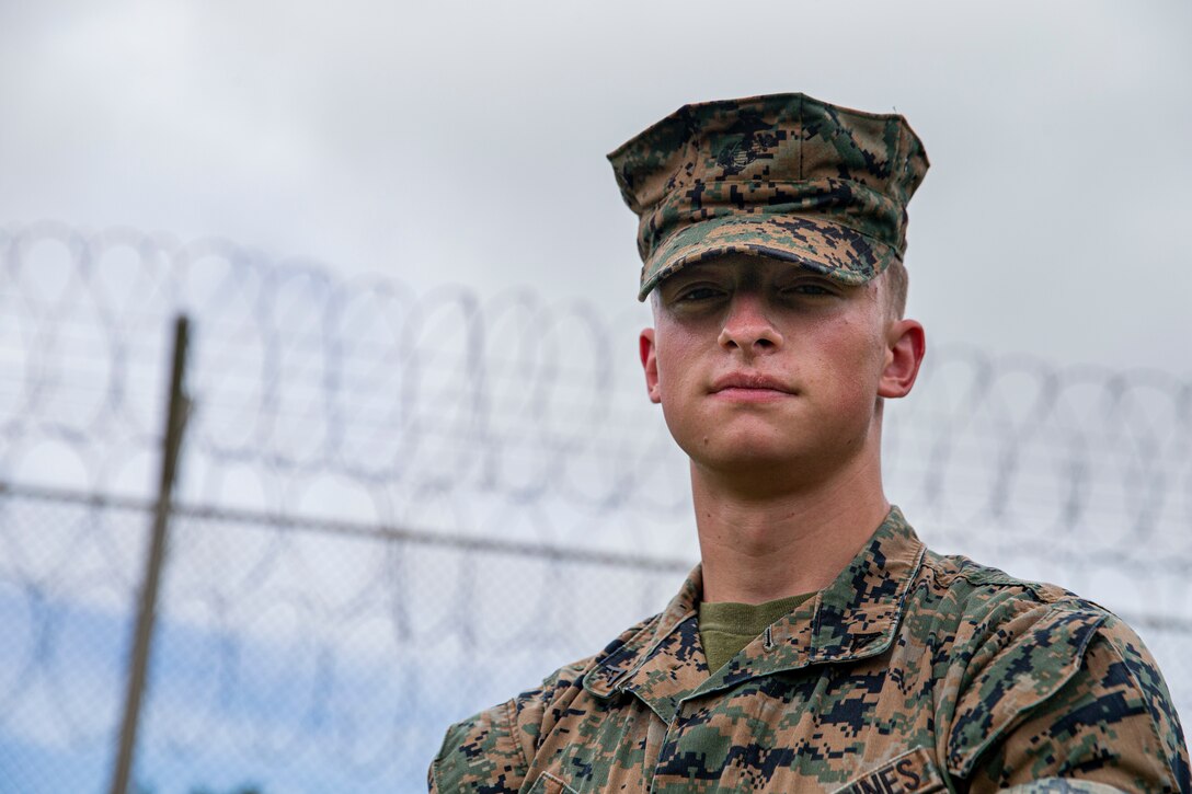 U.S. Marine Corps Lance Cpl. Zachary Schafer, a correctional specialist with the Marine Corps Installations Pacific (MCIPAC) Brig, poses for an environmental portrait on Camp Hansen, Okinawa, Japan, Aug. 5, 2021. Born and raised in Lincoln, Illinois, Schafer always had aspirations to join the ranks of law enforcement. As a correctional specialist, Schafer is responsible for the well-being, good order and security of the prisoners at the MCIPAC Brig. (U.S. Marine Corps photo by Lance Cpl. Alex Fairchild)