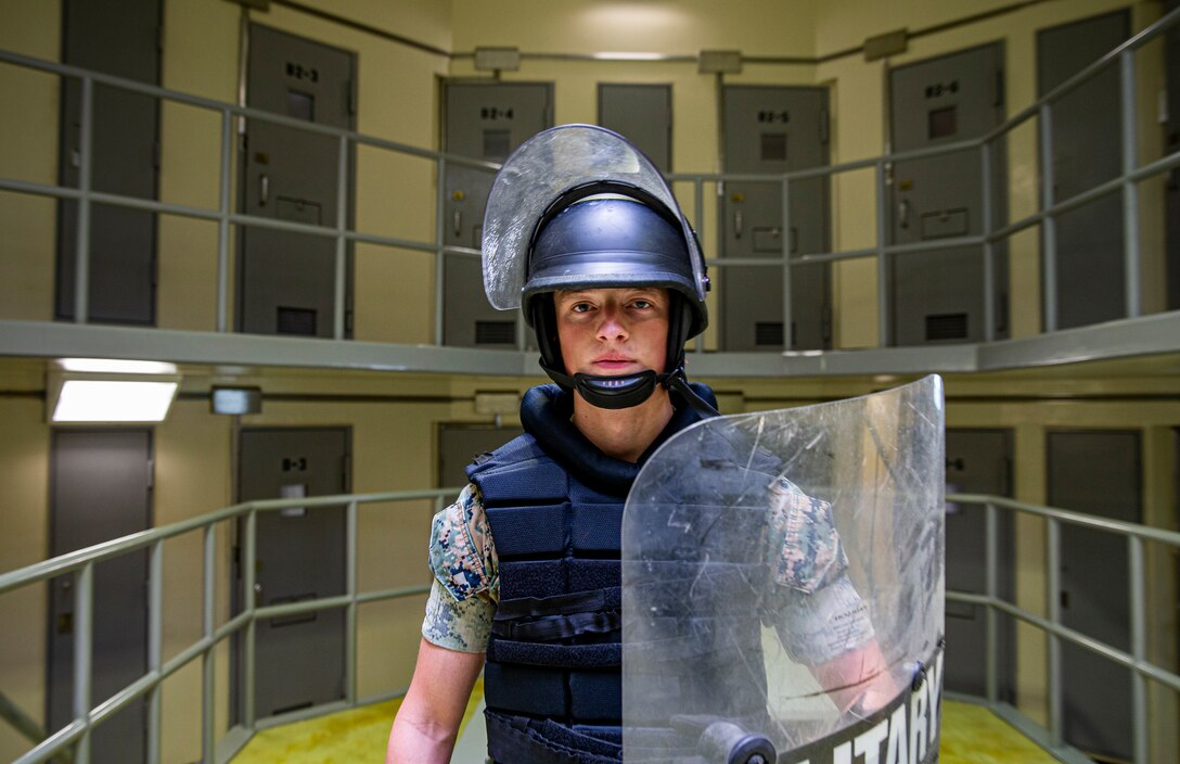 U.S. Marine Corps Lance Cpl. Zachary Schafer, a correctional specialist with the Marine Corps Installations Pacific (MCIPAC) Brig, conducts simulated riot training on Camp Hansen, Okinawa, Japan, Aug. 5, 2021. Born and raised in Lincoln, Illinois, Schafer always had aspirations to join the ranks of law enforcement. As a correctional specialist, Schafer is responsible for the well-being, good order and security of the prisoners at the MCIPAC Brig. (U.S. Marine Corps photo by Lance Cpl. Alex Fairchild)
