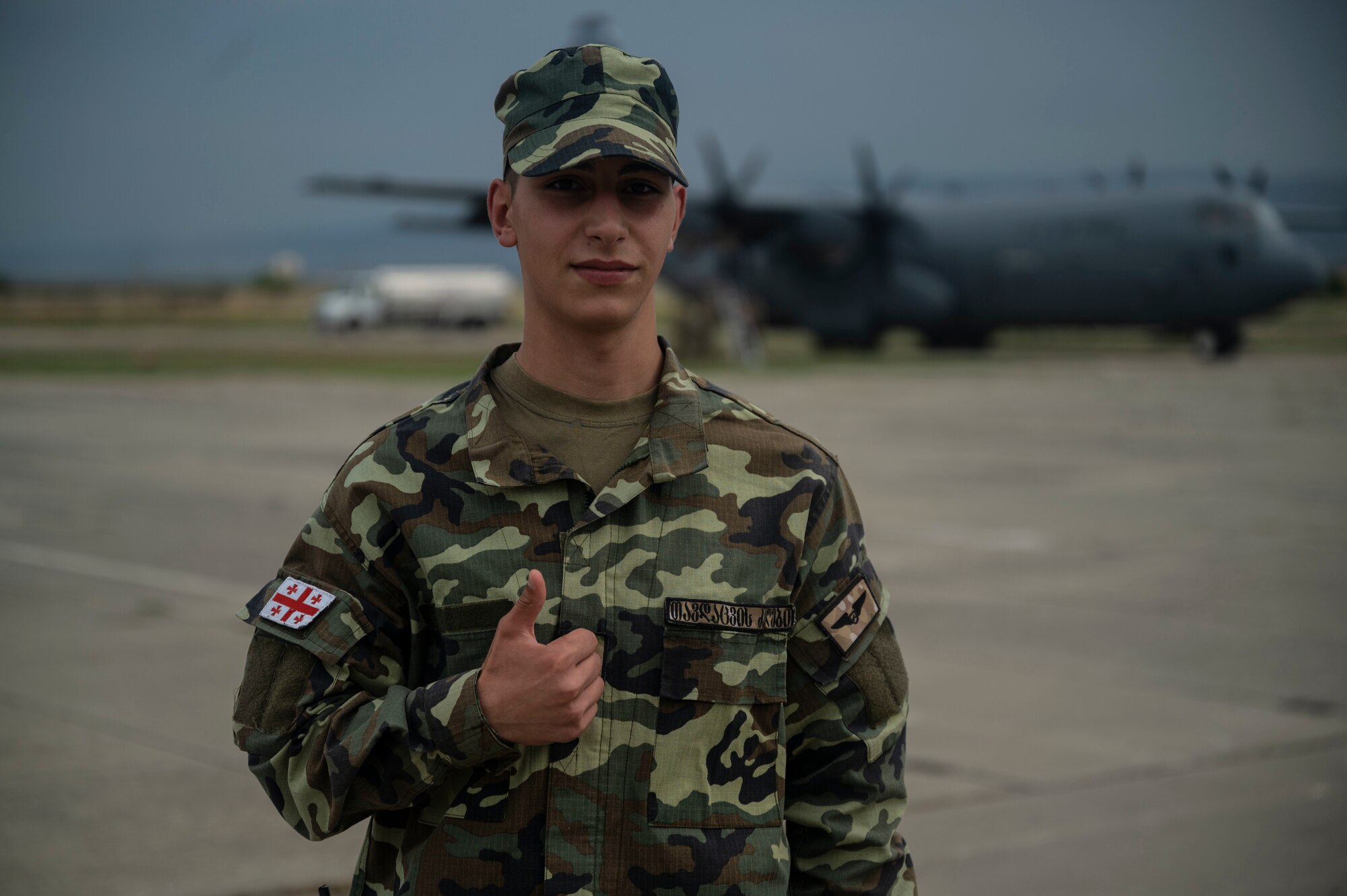 Georgian army Pvt. George Miroiani, stands guard at the flightline during exercise Agile Spirit 21